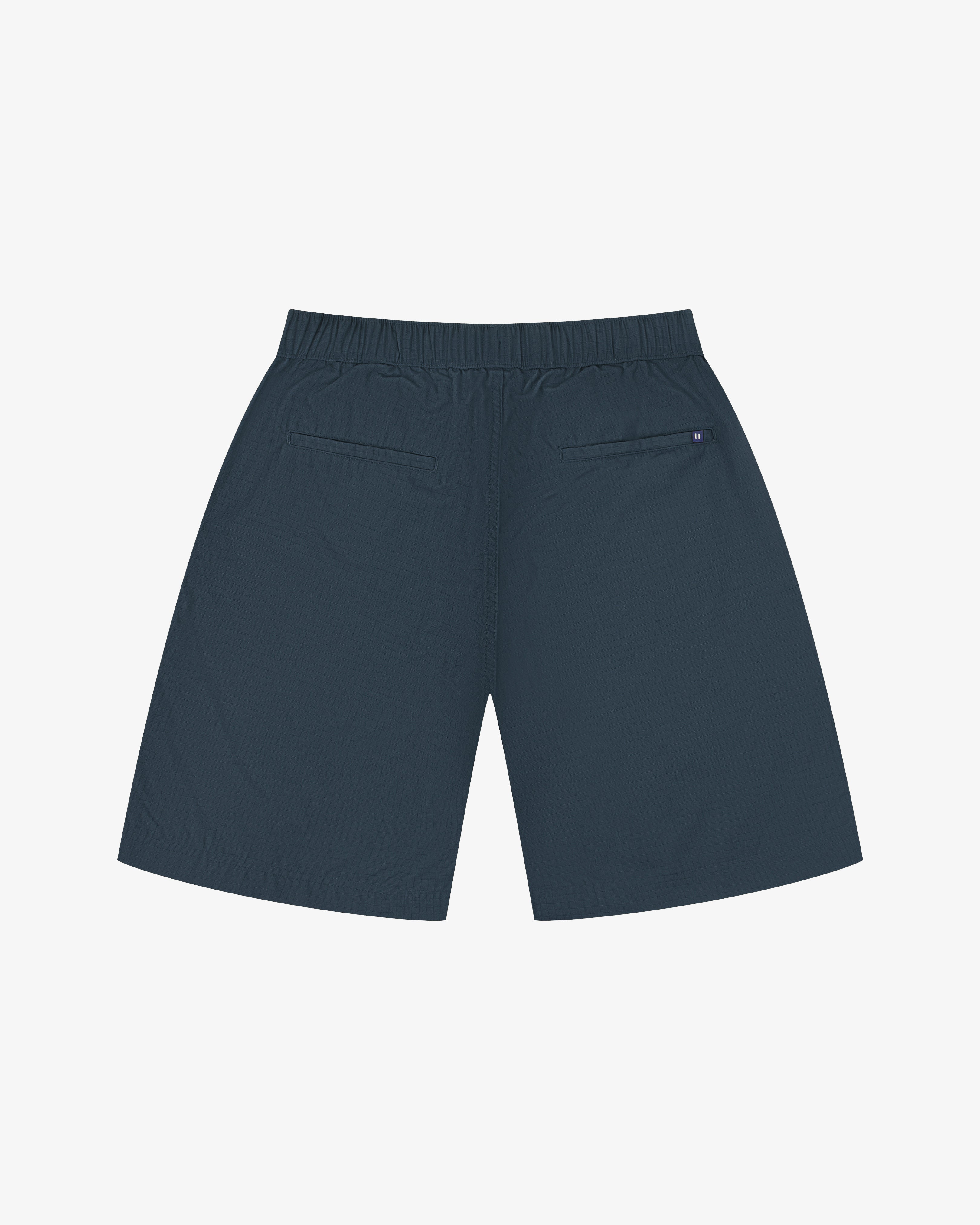 Back view of blueberry men's 5024 ripstop utility shorts by Uskees. Clear view of the two jetted pockets and discreet logo label.