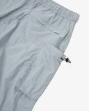 Close-up of pale blue-grey Technique trekking shorts for men showing the elasticated waist, back welt pocket and right gusset pocket with elasticated toggle.
