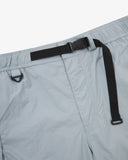 Close-up front view of pale blue-grey Technique trekking shorts for men showing the elasticated waist, triangle carabiner and built-in belt.