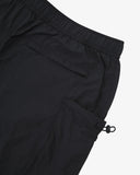 Close-up of black Technique trekking shorts for men showing the elasticated waist, back welt pocket and right gusset pocket with elasticated toggle.