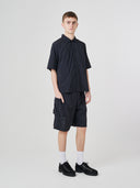 Full-length view of male model wearing Uskees 5026 black Technique trekking shorts with a matching Uskees shirt.