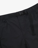 Close-up front view of black Technique trekking shorts for men showing the elasticated waist, triangle carabiner and built-in belt.