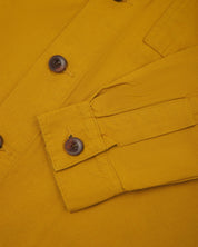 front detail view of uskees bright yellow workshirt for men showing corozo buttons
