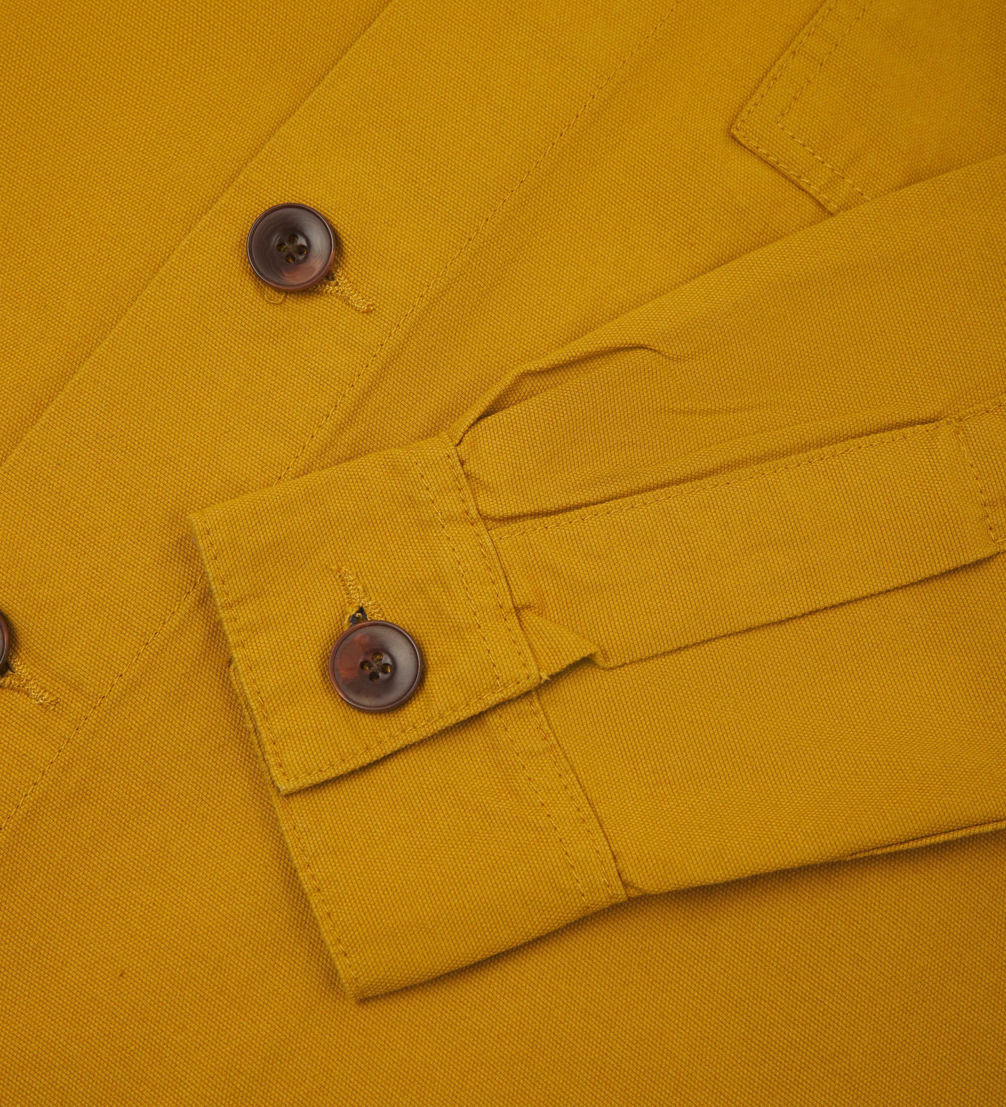 front detail view of uskees bright yellow workshirt for men showing corozo buttons