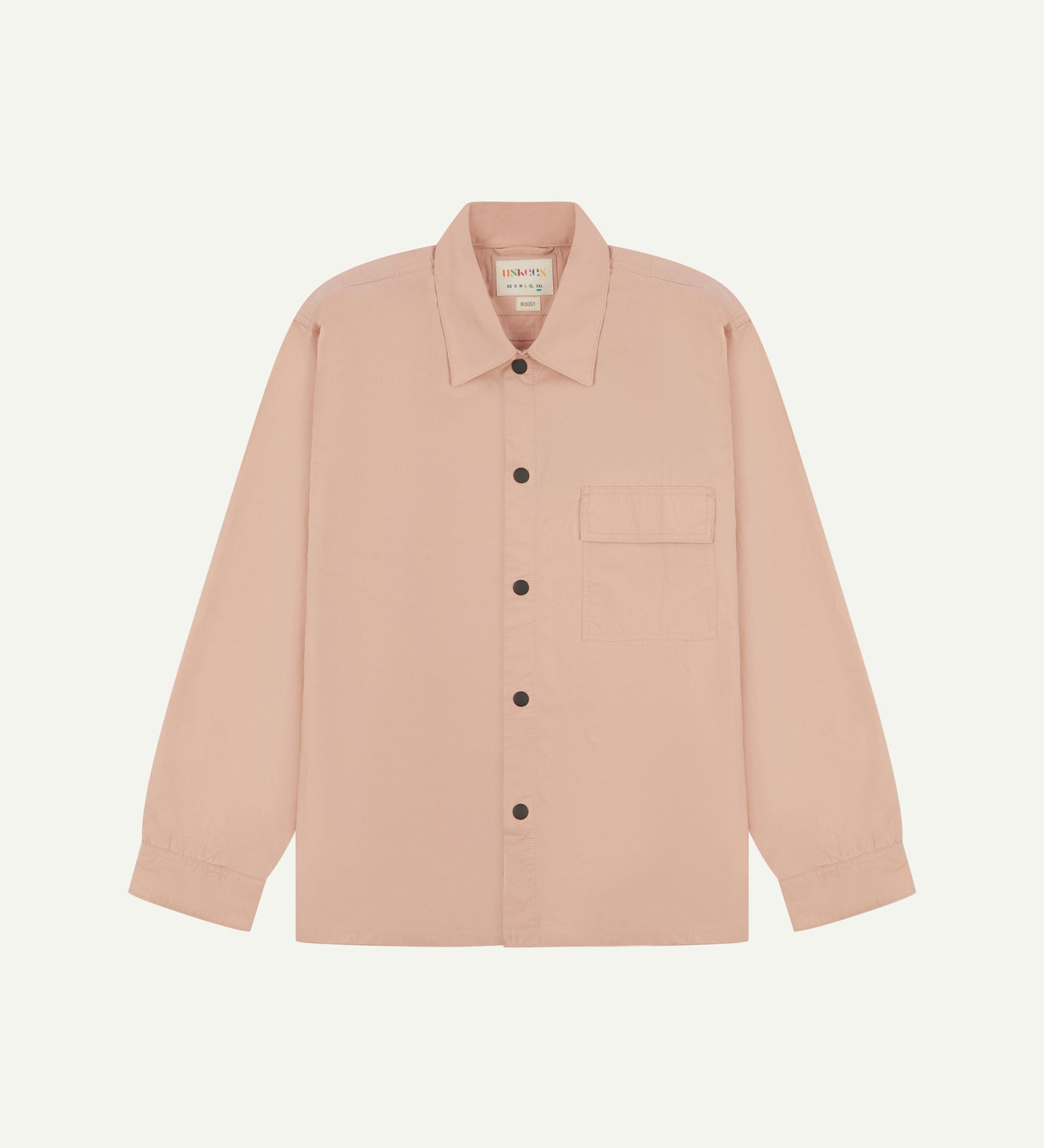 Front flat view of dusty pink, lightweight overshirt. Clear view of the press studs, breast pocket and Uskees branding label.
