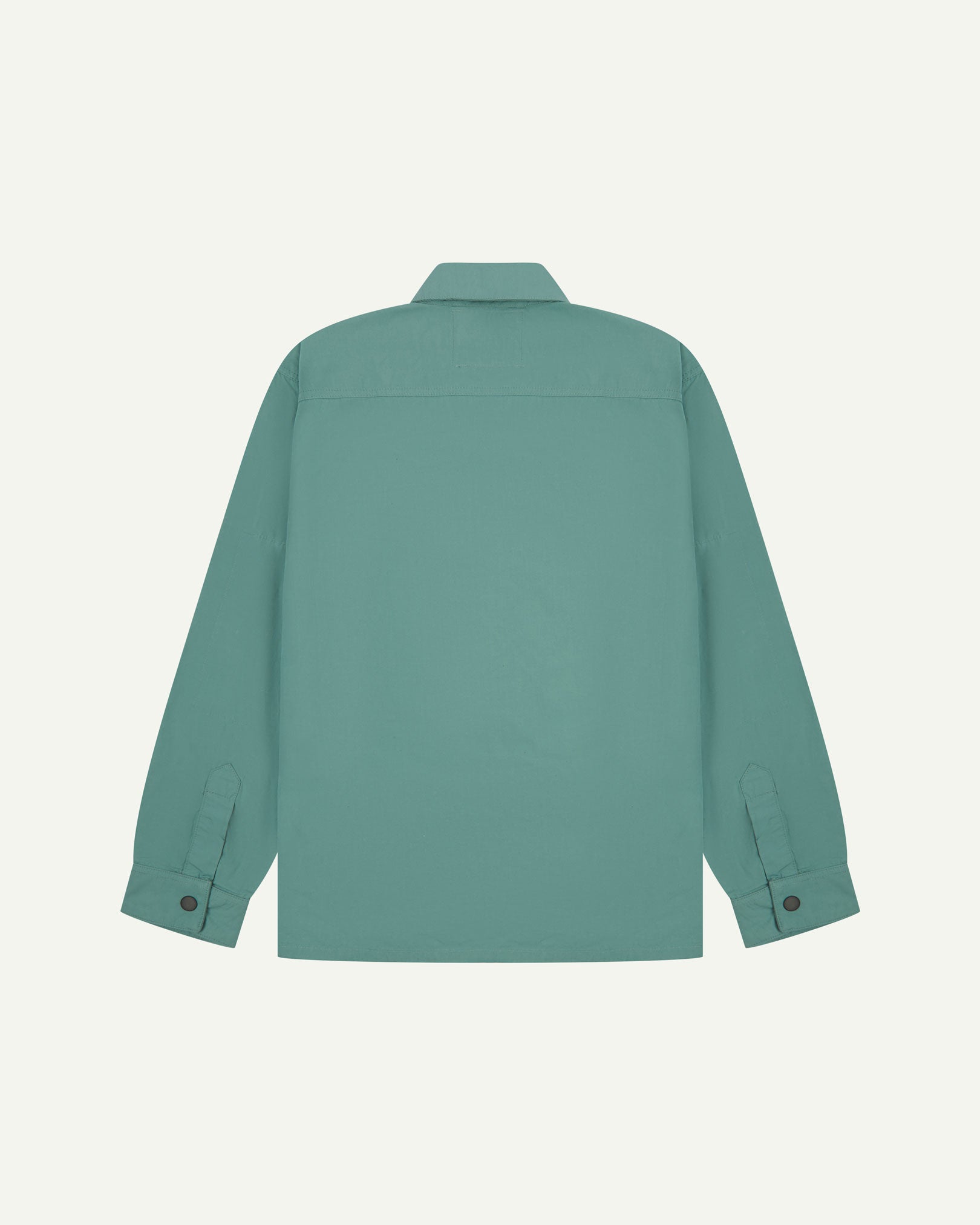 Reverse view of blue-green eucalyptus, lightweight overshirt showing reinforced elbows, boxy silhouette and 'popper' cuffs.