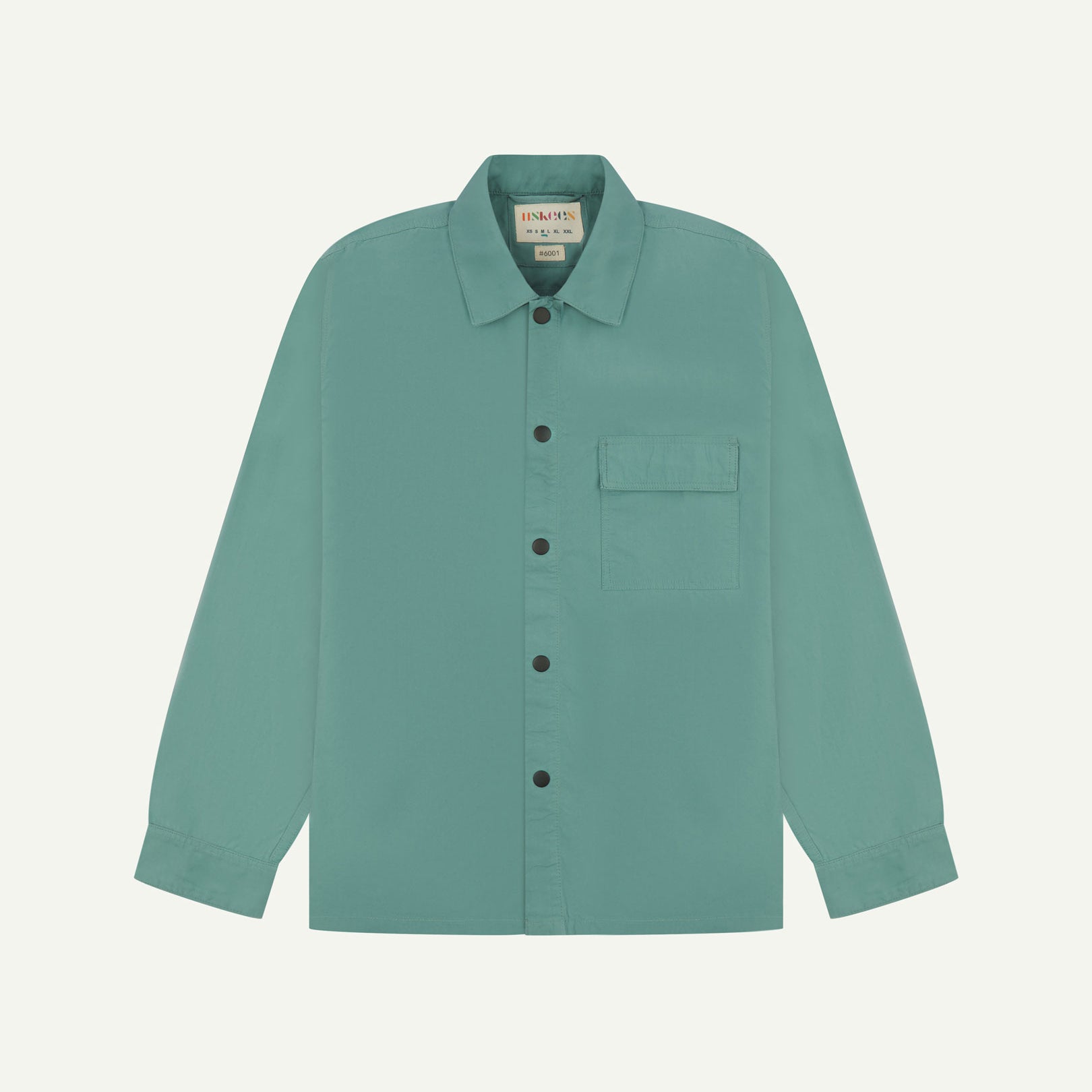 Front flat view of blue-green eucalyptus, lightweight overshirt. Clear view of the press studs, breast pocket and Uskees branding label.