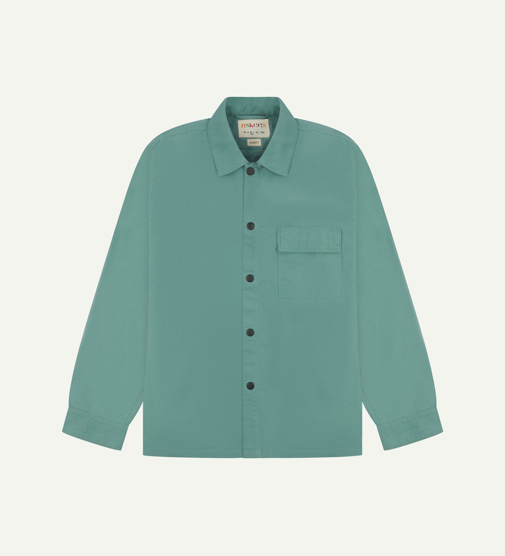 Front flat view of blue-green eucalyptus, lightweight overshirt. Clear view of the press studs, breast pocket and Uskees branding label.