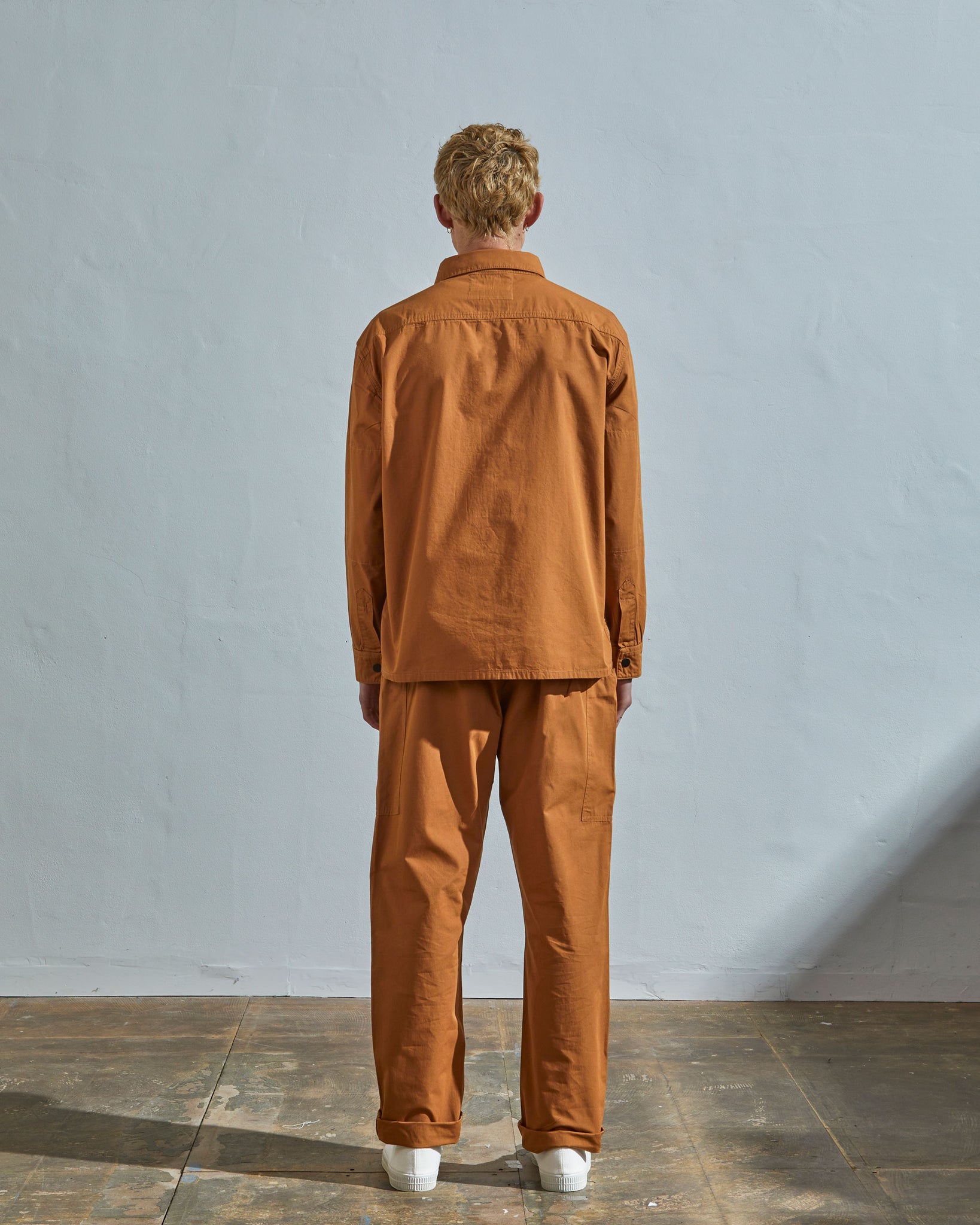 Full-length rear view of model wearing #6001, pale brown over shirt showing reinforced elbows.
