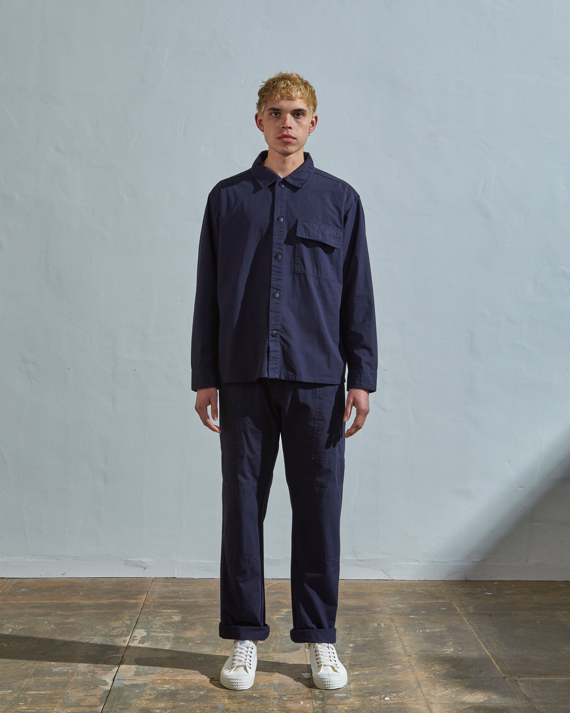 Full-length front view of model wearing #6001, midnight blue over shirt paired with matching #5011 lightweight pants.