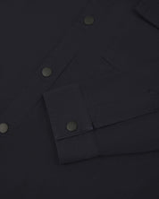 View of the mid-section of the midnight blue 6001 lightweight overshirt from Uskees, with focus on the popper buttons and reinforced cuff, placket and sleeve.