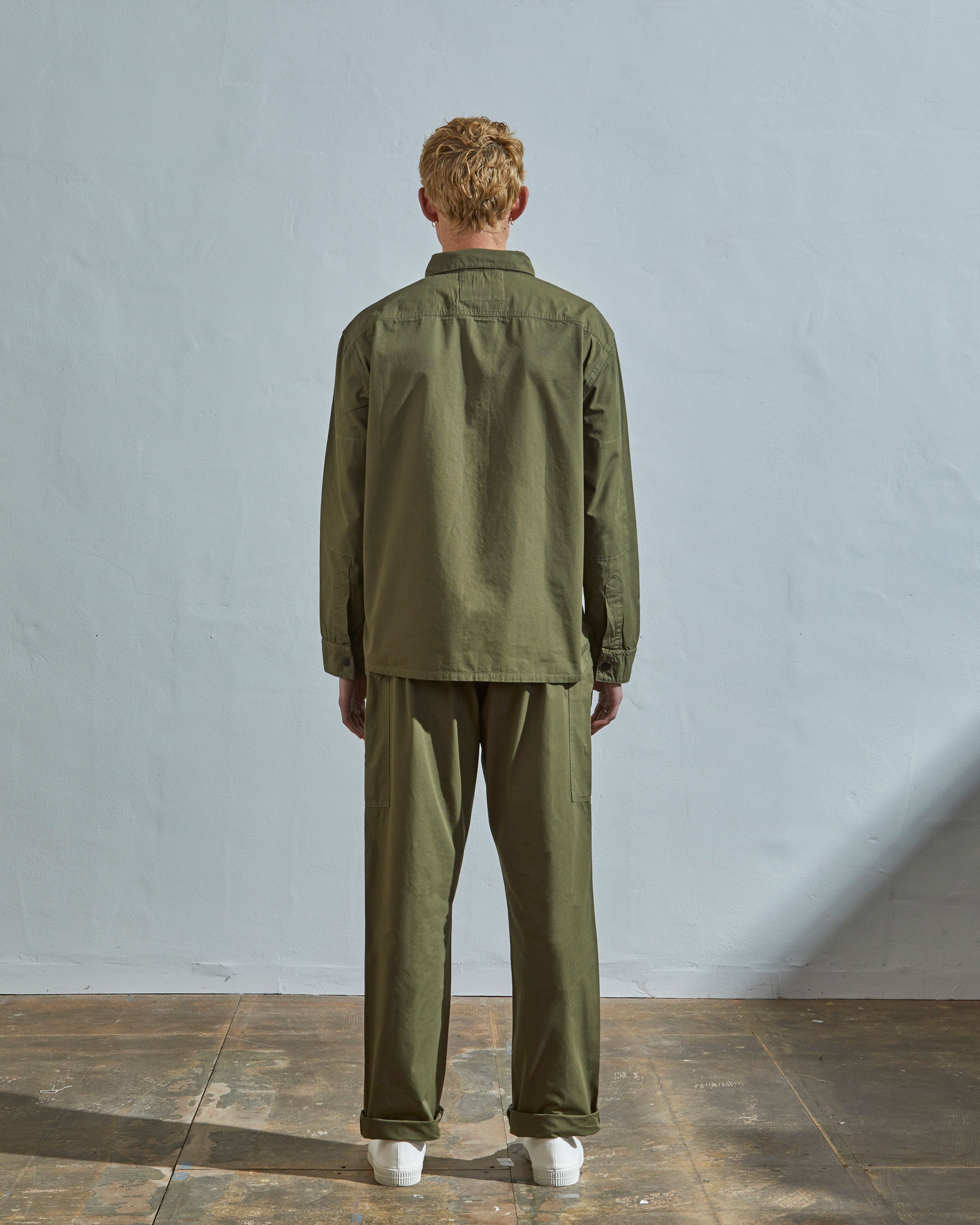 Full-length rear view of model wearing #6001, olive over shirt showing reinforced elbows.