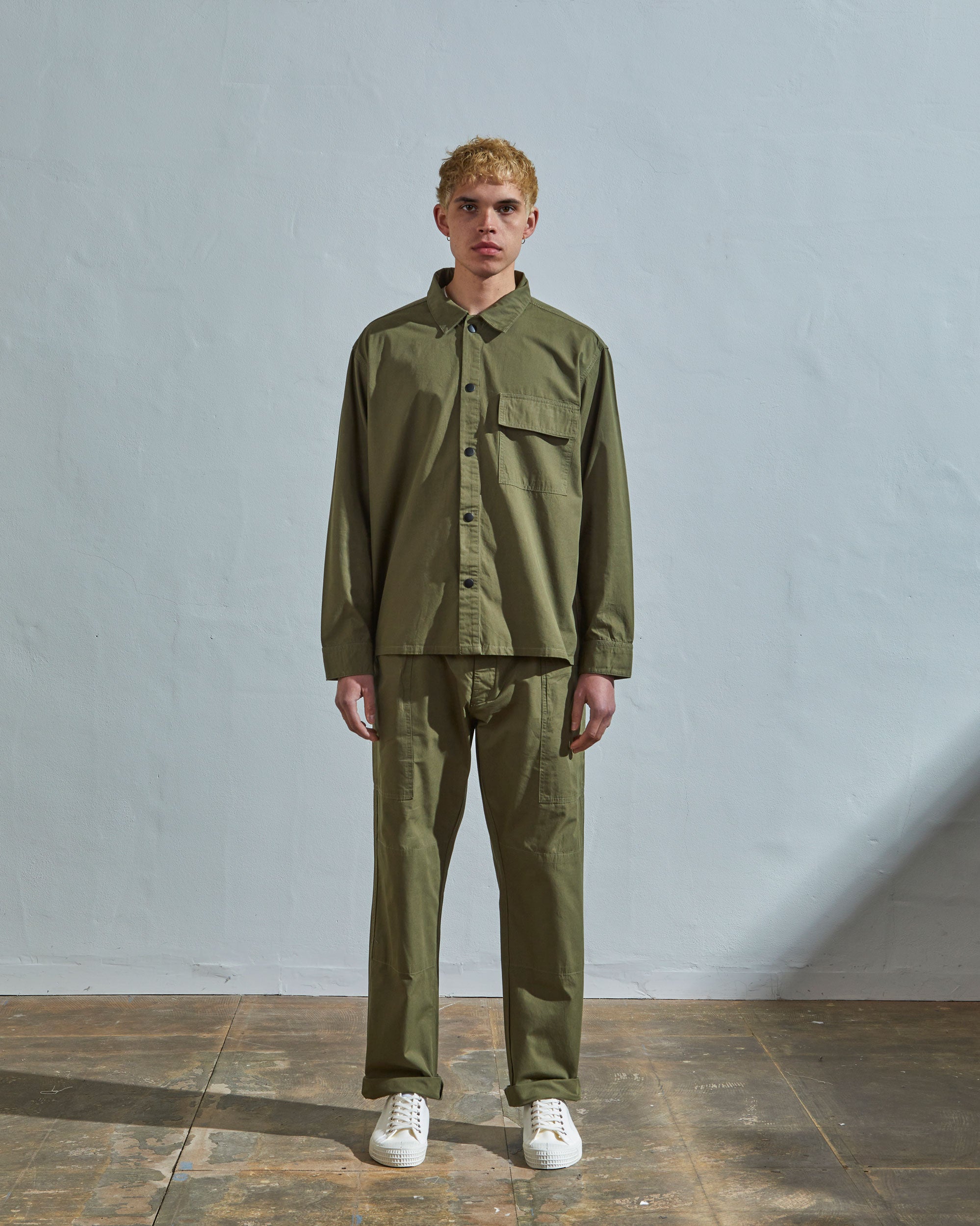 Full-length front view of model wearing #6001, olive over shirt paired with matching #5011 lightweight pants.