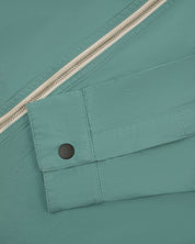 View of the mid-section of the blue-green 'eucalyptus' coloured 6002 lightweight jacket from Uskees, with focus on the cuff and front zipper detail.