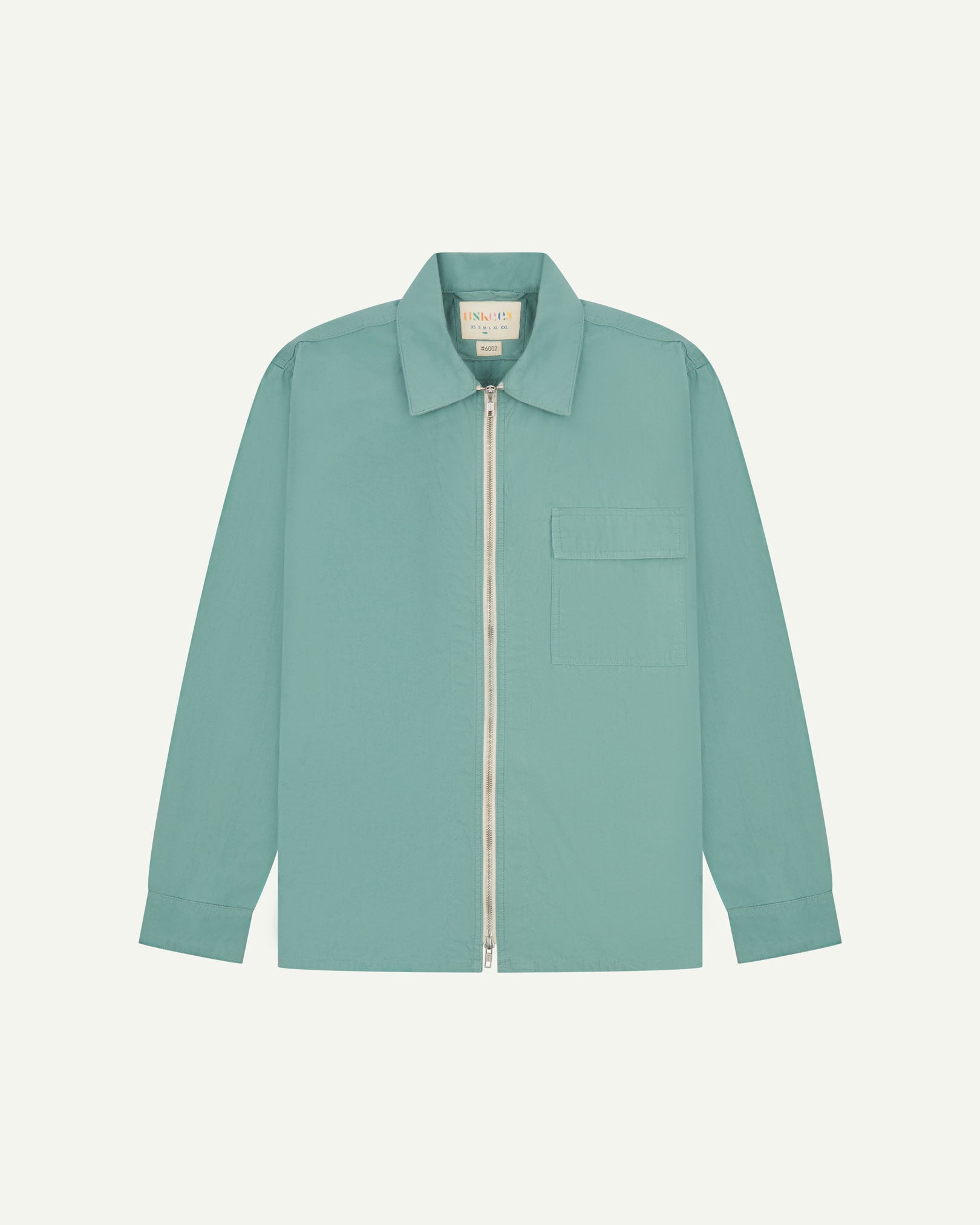 Front flat view of the blue-green 'eucalyptus' coloured, lightweight zip-front jacket. Clear view of zipper, breast pocket and Uskees branding label.