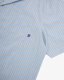 Close up view of Uskees blue, gold and white striped cuban shirt for men with focus on the chest pocket and Uskees label tab.