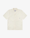 Front flat shot of Uskees off-white Cuban linen blend shirt for men. Clear view of corozo buttons, chest pocket and Uskees branding labels.