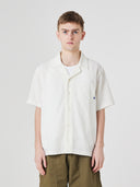 Front model shot of Uskees cream linen blend short-sleeve Cuban men's shirt on a white background