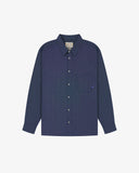 Flat front view of mid blue organic chambray Oxford shirt from Uskees. Clearly showing loose fit and 8-button front.