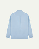 Flat back view of sky blue organic cotton Oxford shirt from Uskees with view of open pleat and longer rear hem so it can be tucked in more easily.