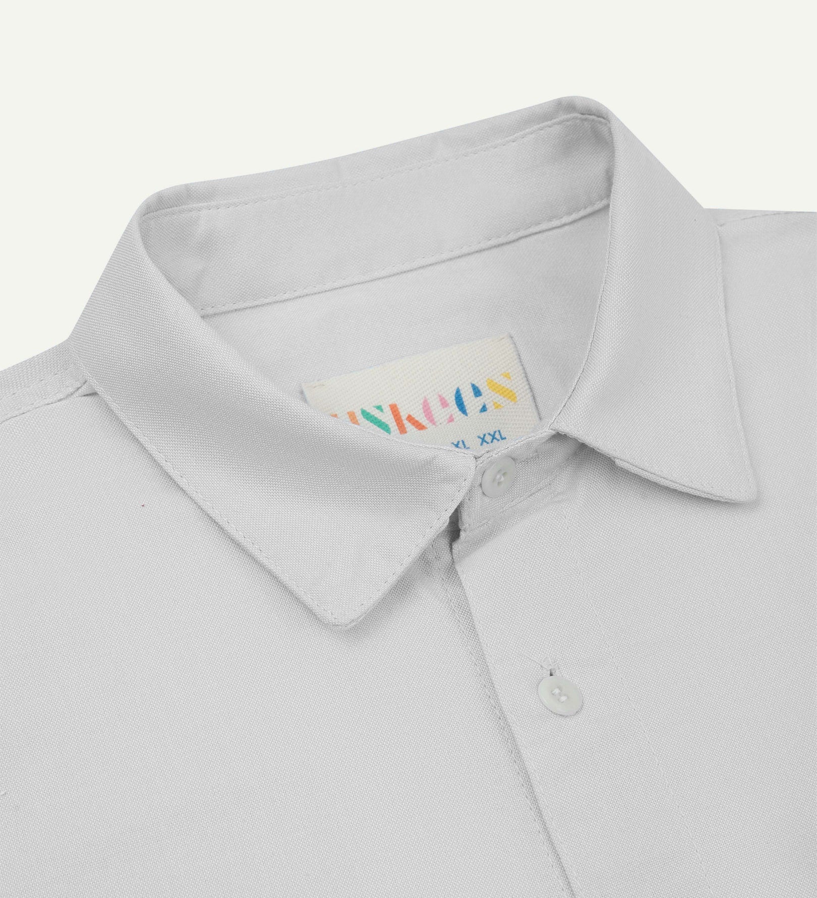 Close-up and angled front view of the 6006 Oxford shirt showing the texture of the organic cotton, the collar and Uskees brand label.