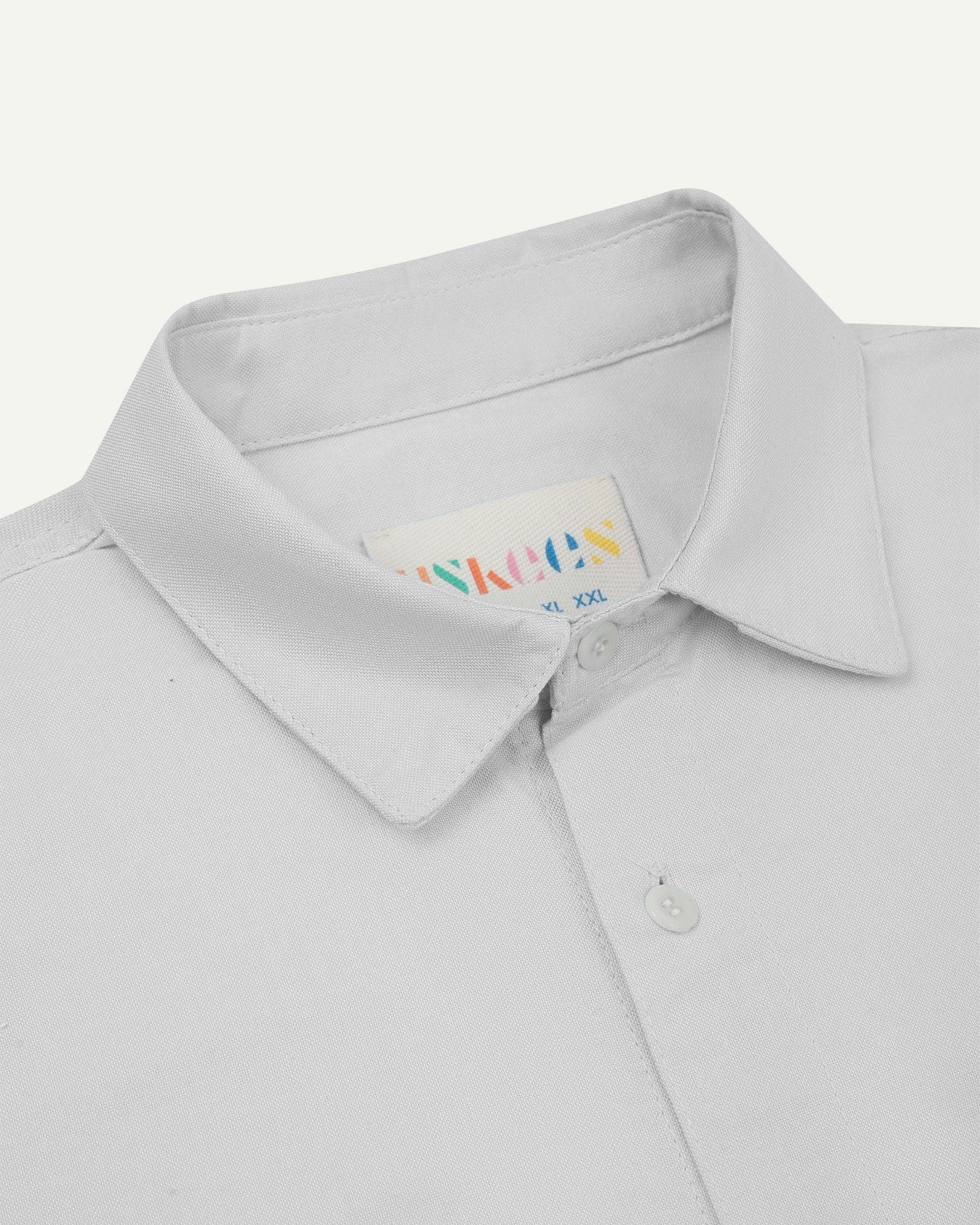 Close-up and angled front view of the 6006 Oxford shirt showing the texture of the organic cotton, the collar and Uskees brand label.