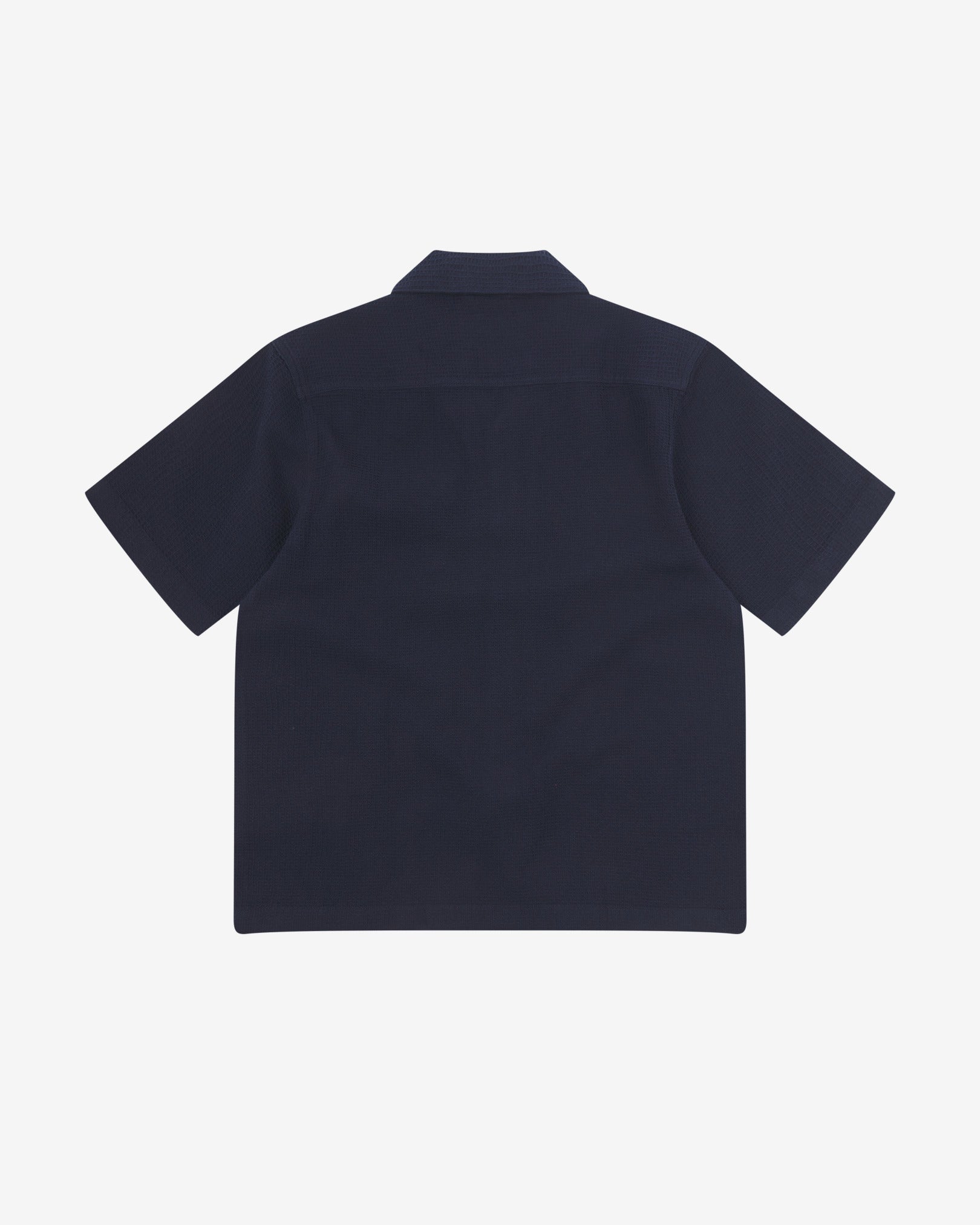 Reverse flat view of deep blue organic cotton waffle fabric short sleeve shirt from Uskees showing loose, relaxed style.