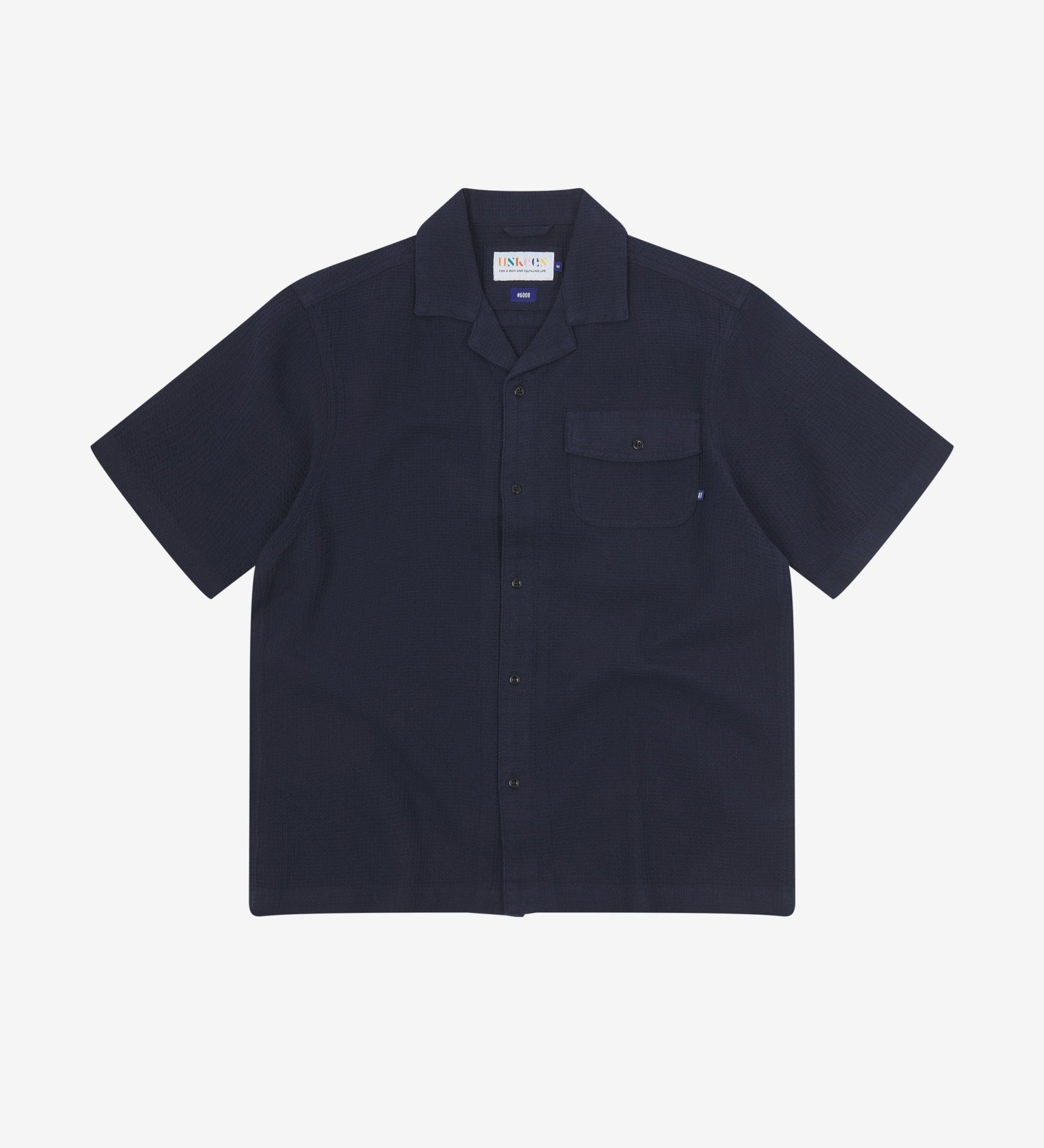 Front flat view of Capri Camp buttoned short sleeve shirt from Uskees with deep blue organic cotton waffle fabric.