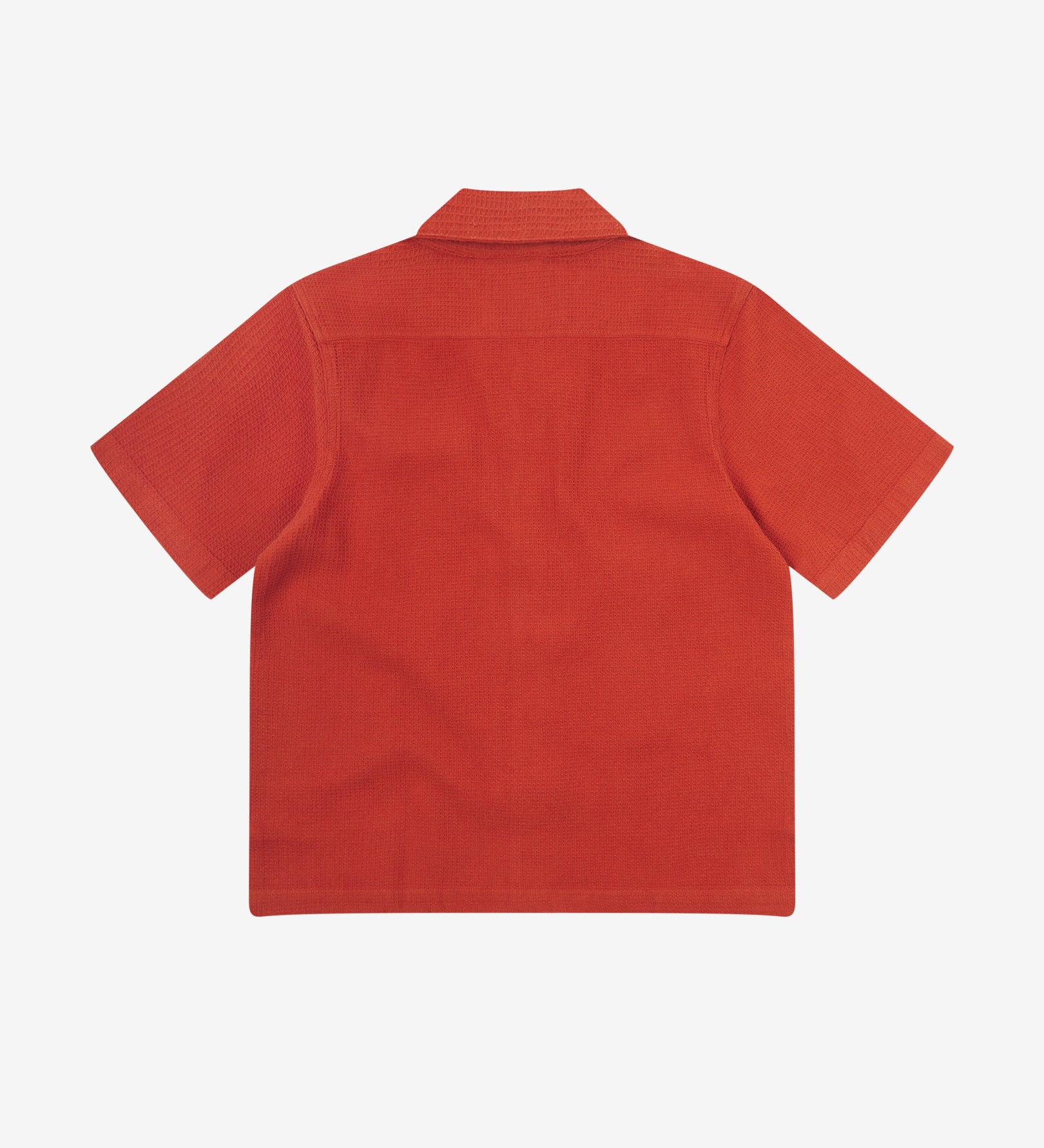 Reverse flat view of rust-red organic cotton waffle fabric short sleeve shirt from Uskees showing loose, relaxed style.