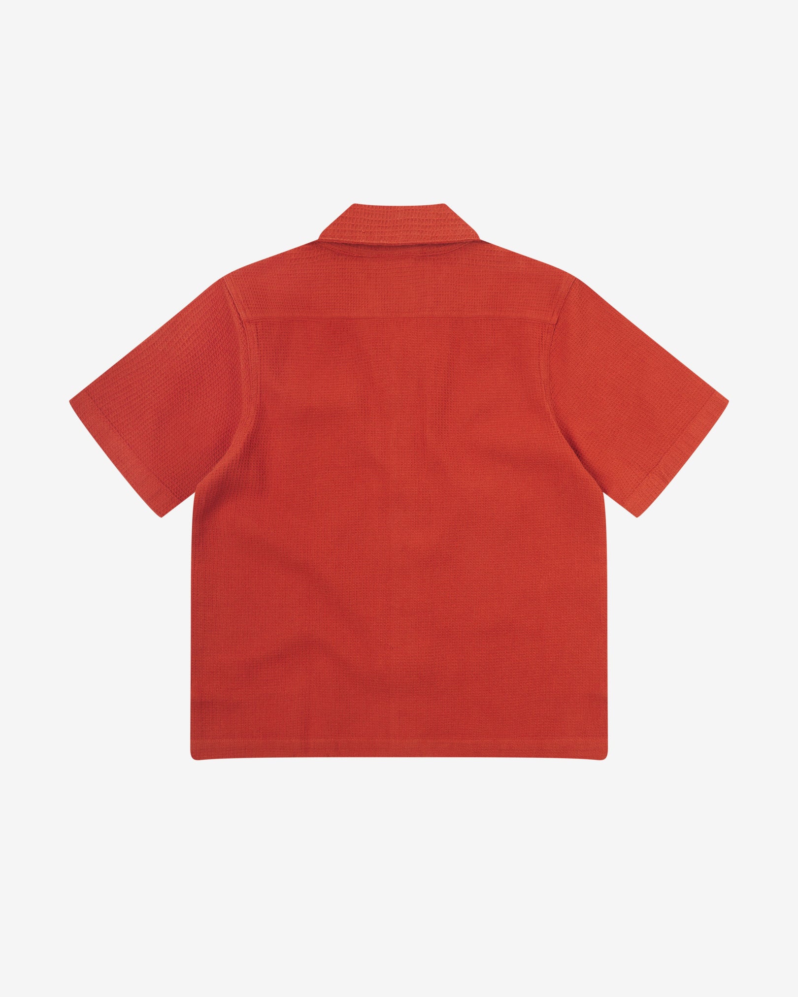 Reverse flat view of rust-red organic cotton waffle fabric short sleeve shirt from Uskees showing loose, relaxed style.