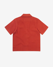 Reverse flat view of rust-red organic cotton waffle fabric short sleeve shirt from Uskees showing loose, relaxed style.