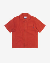 Front flat view of Capri Camp buttoned short sleeve shirt from Uskees with rust-red organic cotton waffle fabric.