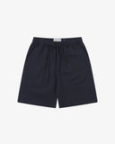 Front flat shot of Uskees dark blue shorts for men. Clear view of drawstring, elasticated waist and Uskees branding label.
