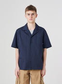 Top-half front view of model wearing an Uskees dark blue Cuban shirt demonstrating relaxed, casual fit.