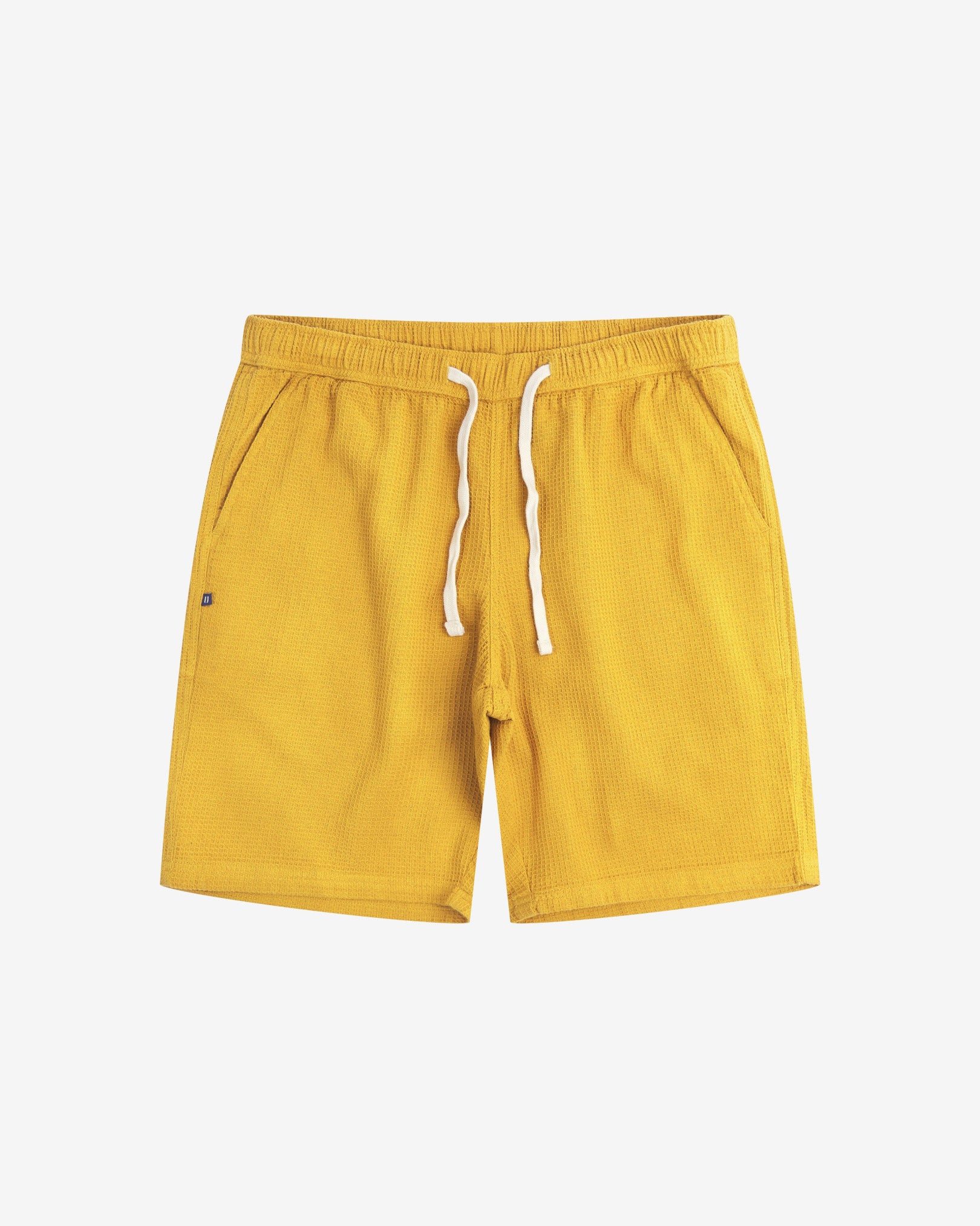 Front view of yellow #6009 waffle cotton shorts by Uskees. Clear view of white drawstring, side pockets and small Uskees tag label.