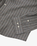 Close-up of an Uskees trafford grey timber leah plaid shirt with focus on buttoned cuff and hemline.