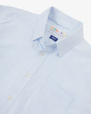 Close up view of Uskees light blue and white striped men's Oxford shirt with focus on collar and Uskees brand label.