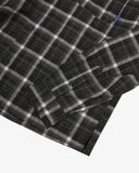Close view of an Uskees charcoal check long sleeved flannel shirt for men showing the sleeve and cuff detail.