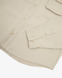 Close view of an Uskees beige long sleeved shirt for men showing the button fastening, sleeve and cuff detail.