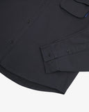 Close view of an Uskees dark blue long sleeved shirt for men showing the button fastening, sleeve and cuff detail.