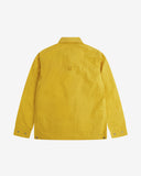 Reverse view of the British yellow Uskees wax storm jacket showing the boxy silhouette, Halley Stevenson dry wax fabric, hanging loop and adjustable hem.