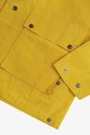 Closer view of the adjustable cuffs on the British yellow Uskees wax storm jacket. Also view of the flap pocket, popper fastenings and subtle Uskees branding label.