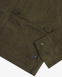 Closer view of the adjustable cuffs on the dark 'Pennine' green Uskees wax storm jacket. Also view of the flap pocket, popper fastenings and subtle Uskees branding label.