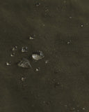 Magnified view of the dry waxed fabric, demonstrating the material's water repellant properties.