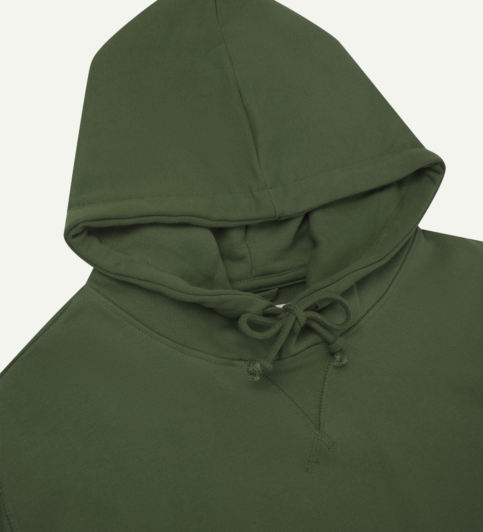 Front close-up view of Uskees coriander-green hoodie showing ties at neck and decorative V pattern.