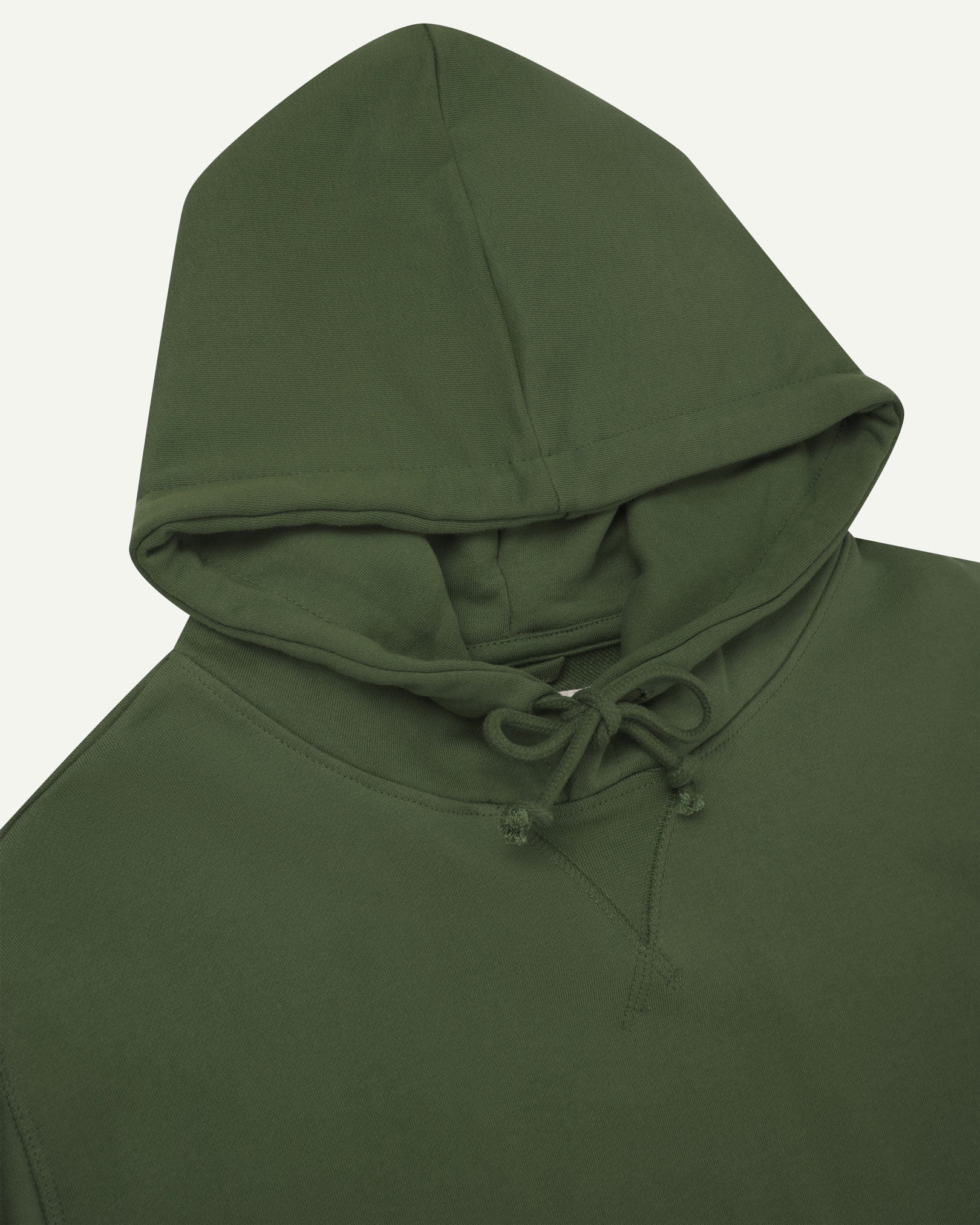 Front close-up view of Uskees coriander-green hoodie showing ties at neck and decorative V pattern.
