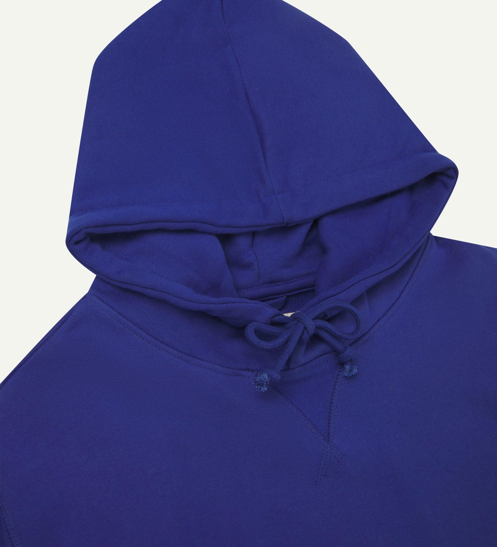 Front close-up view of Uskees 7004 'ultra blue' hoodie showing hood tie detail at neck and decorative V pattern.