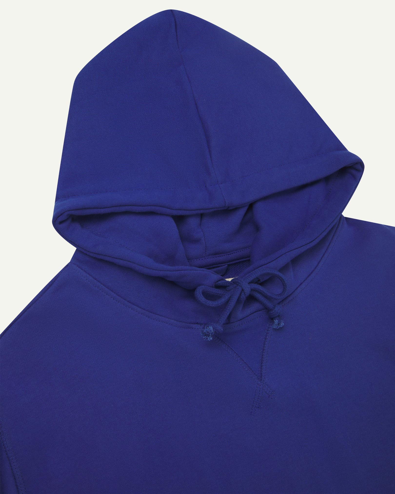 Front close-up view of Uskees 7004 'ultra blue' hoodie showing hood tie detail at neck and decorative V pattern.