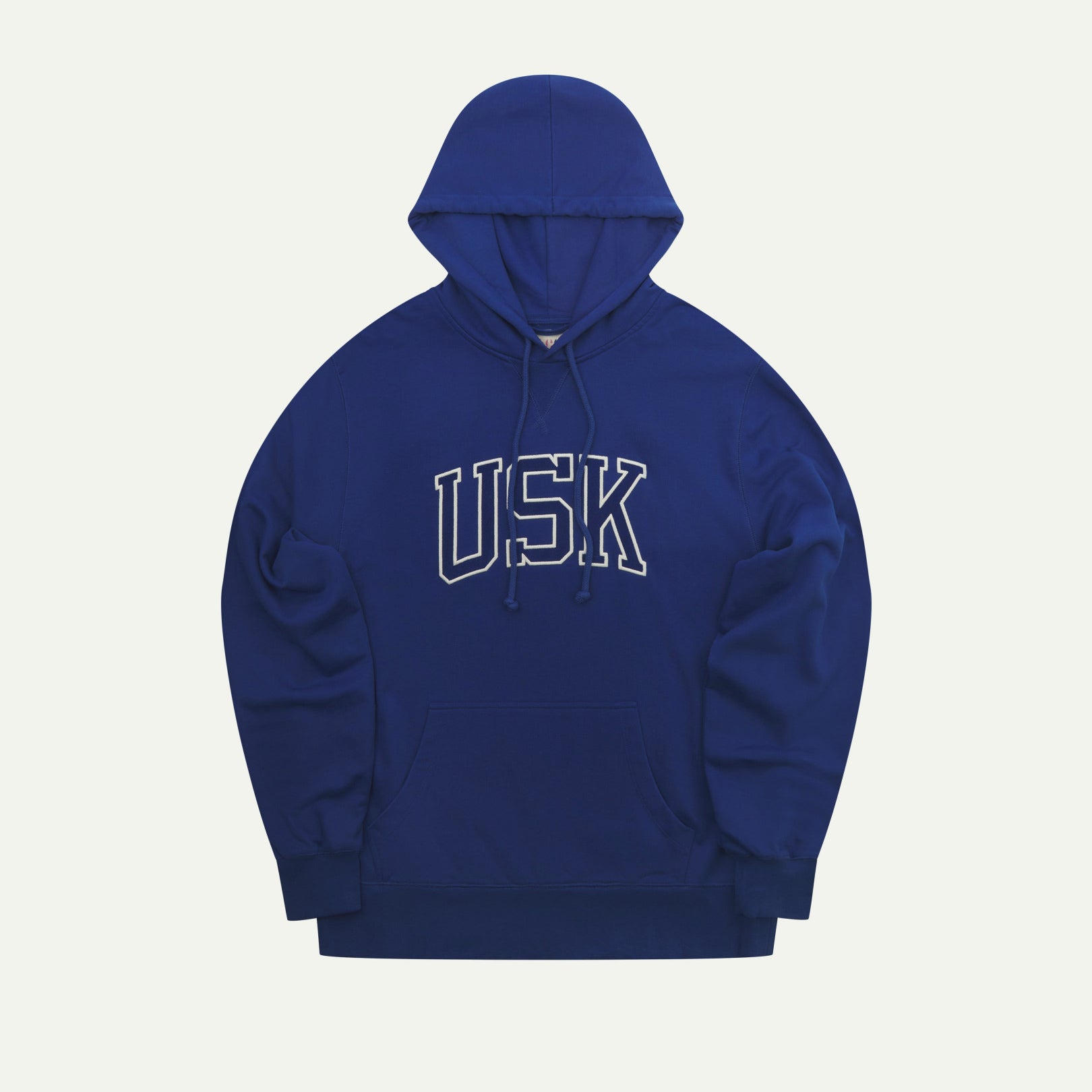 Front flat shot of Uskees signature ultra blue men's hooded sweatshirt showing the 'USK' logo, pouch pocket and drawstring hood.