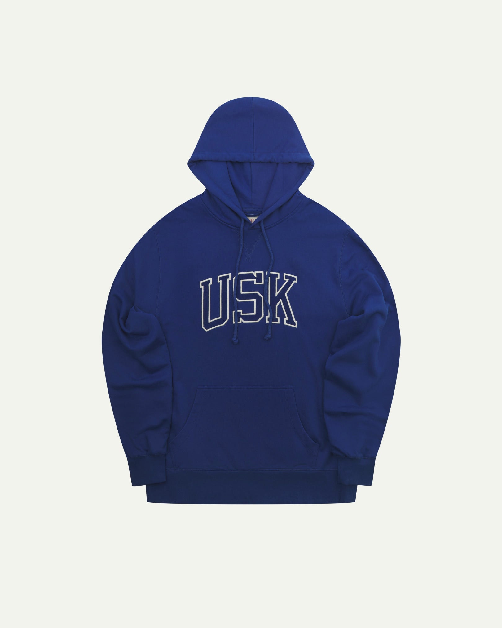 Front flat shot of Uskees signature ultra blue men's hooded sweatshirt showing the 'USK' logo, pouch pocket and drawstring hood.